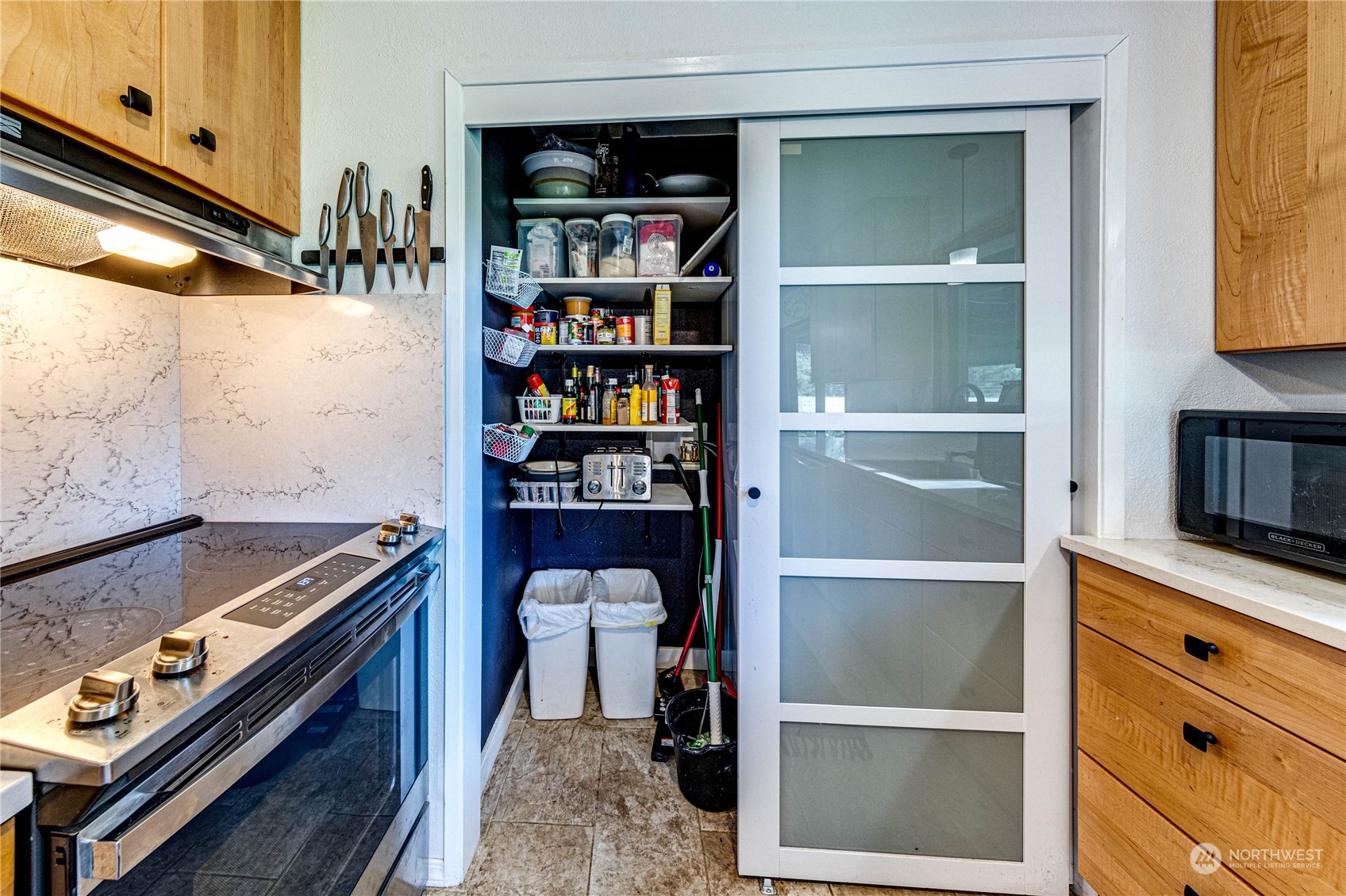 283 Schmitt Road Port Angeles, WA 98363 - Photo 14 of 40 a kitchen with a stove and a bookshelf