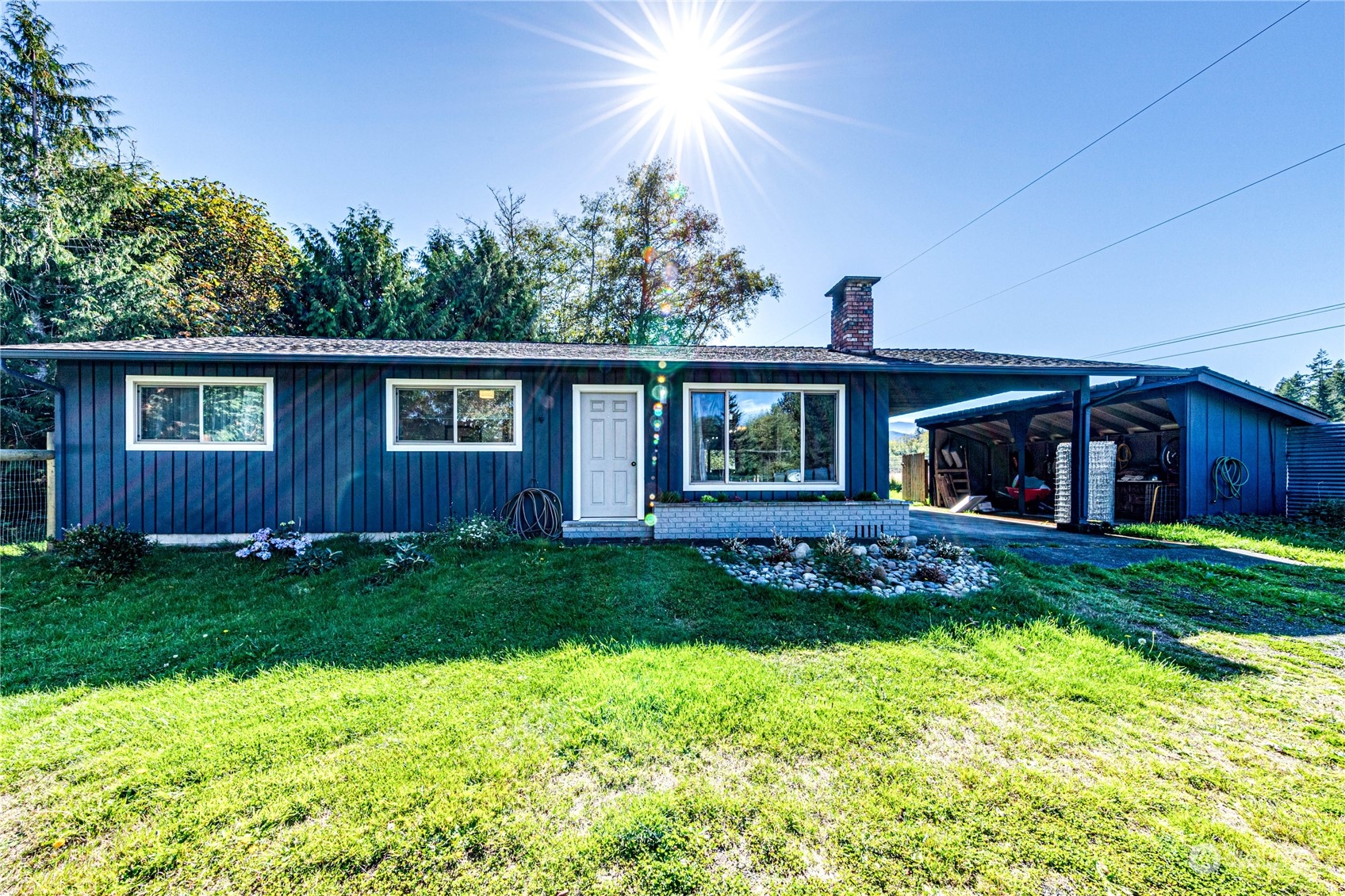 283 Schmitt Road Port Angeles, WA 98363 - Photo 3 of 40 a front view of a house with a garden