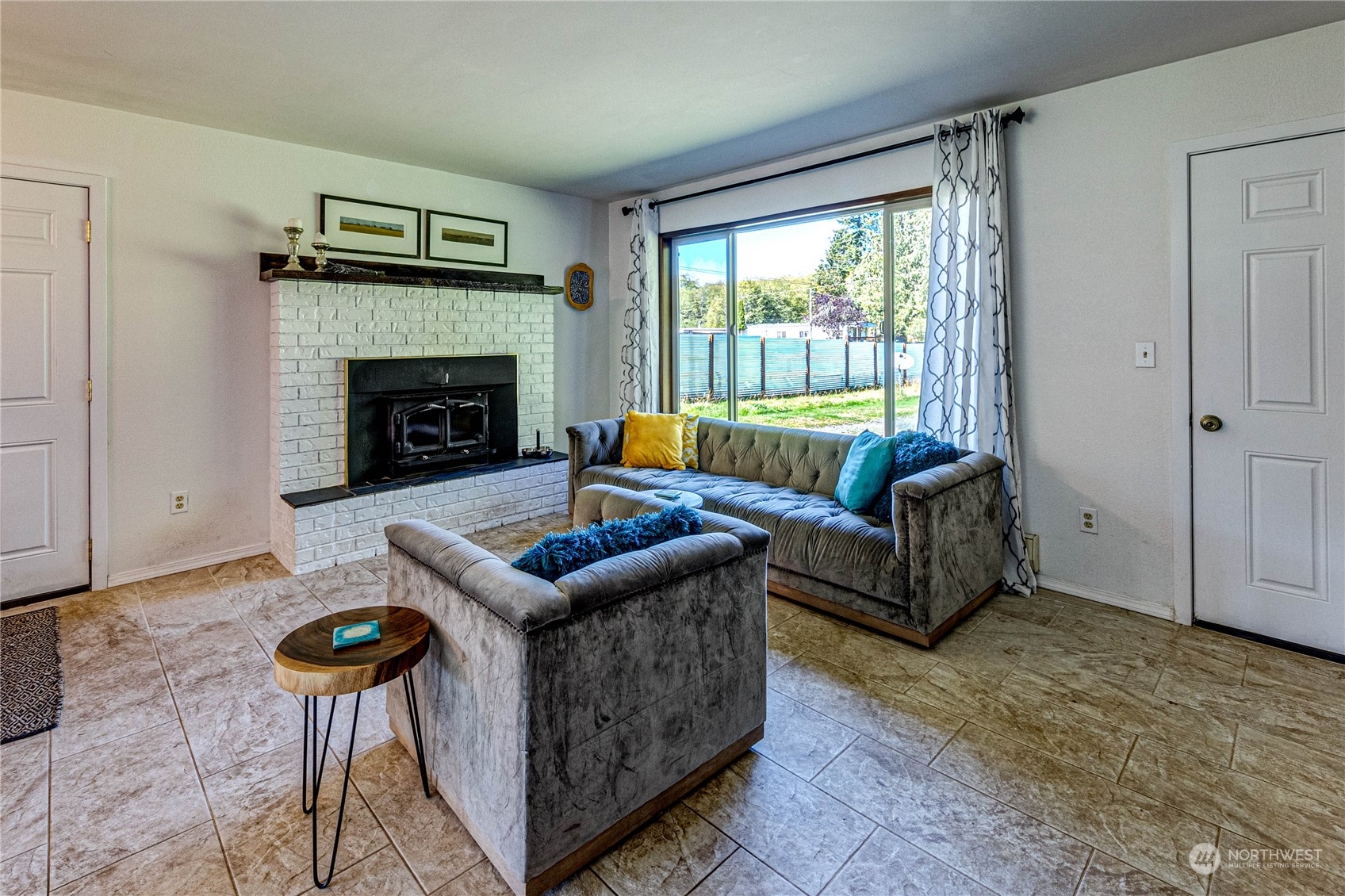 283 Schmitt Road Port Angeles, WA 98363 - Photo 7 of 40 a living room with furniture and a fireplace