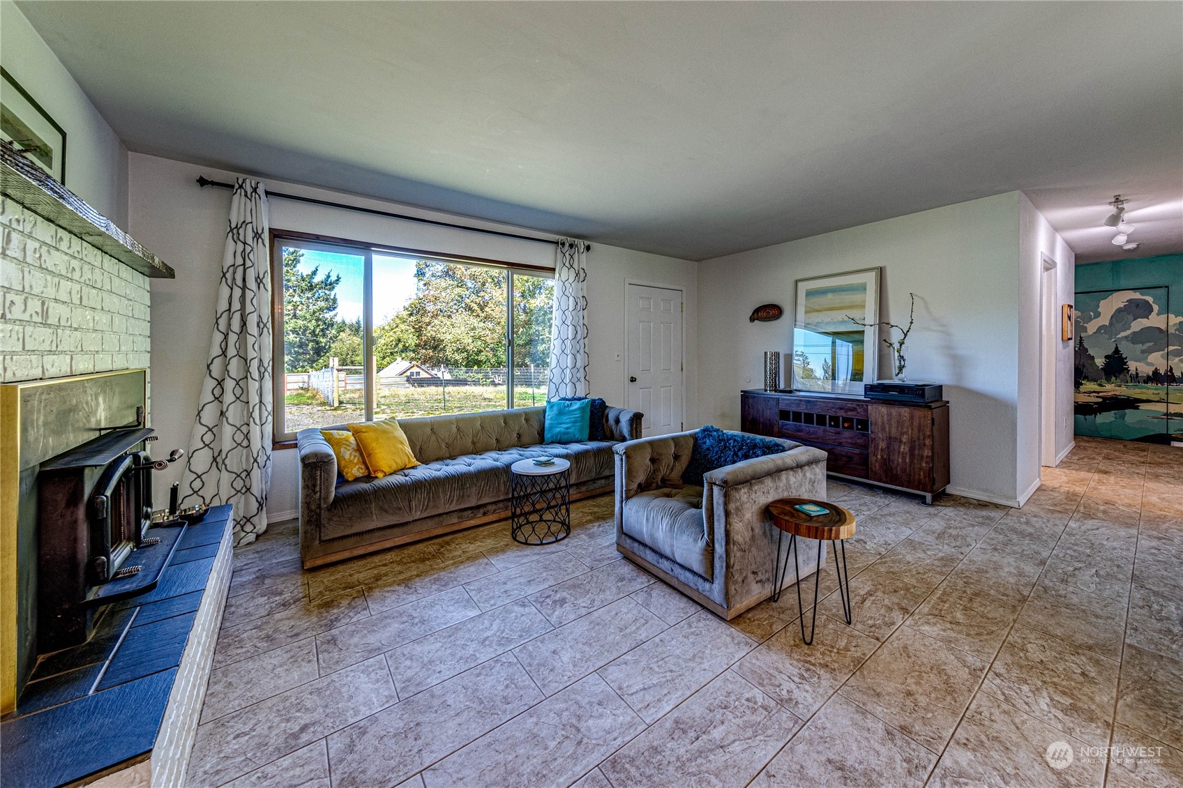 283 Schmitt Road Port Angeles, WA 98363 - Photo 8 of 40 a living room with furniture rug and a fireplace