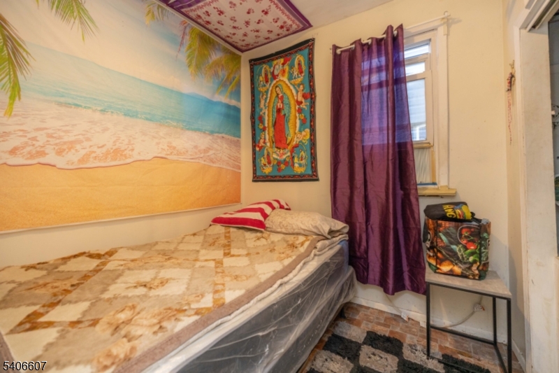 450 3rd Avenue, Unit 2 Elizabeth Port, NJ 07206 - Photo 9 of 23 a bedroom with a bed and painting on the wall