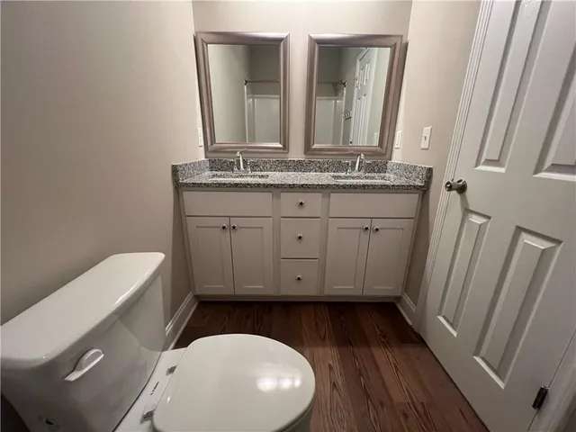 a bathroom with a toilet a sink and mirror