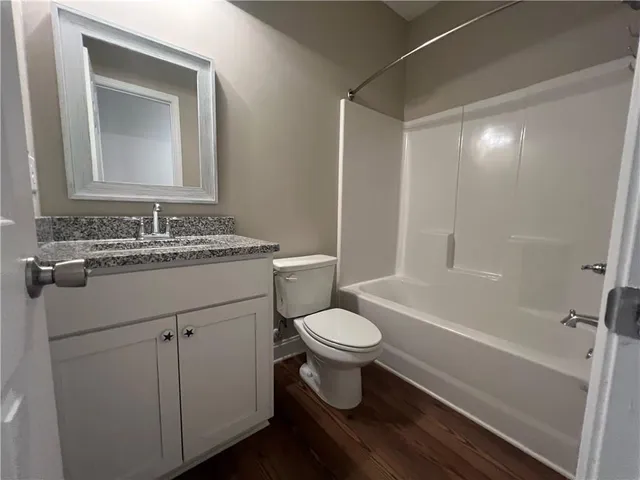 a bathroom with a sink toilet a mirror and shower