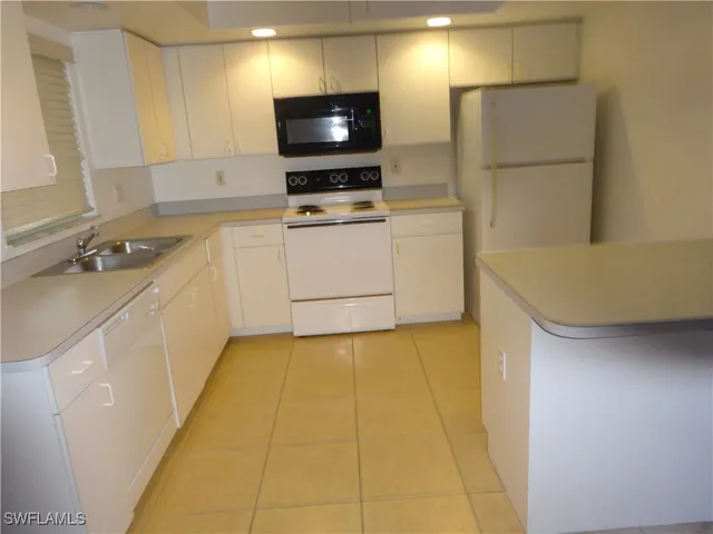 a kitchen with a sink and a stove top oven