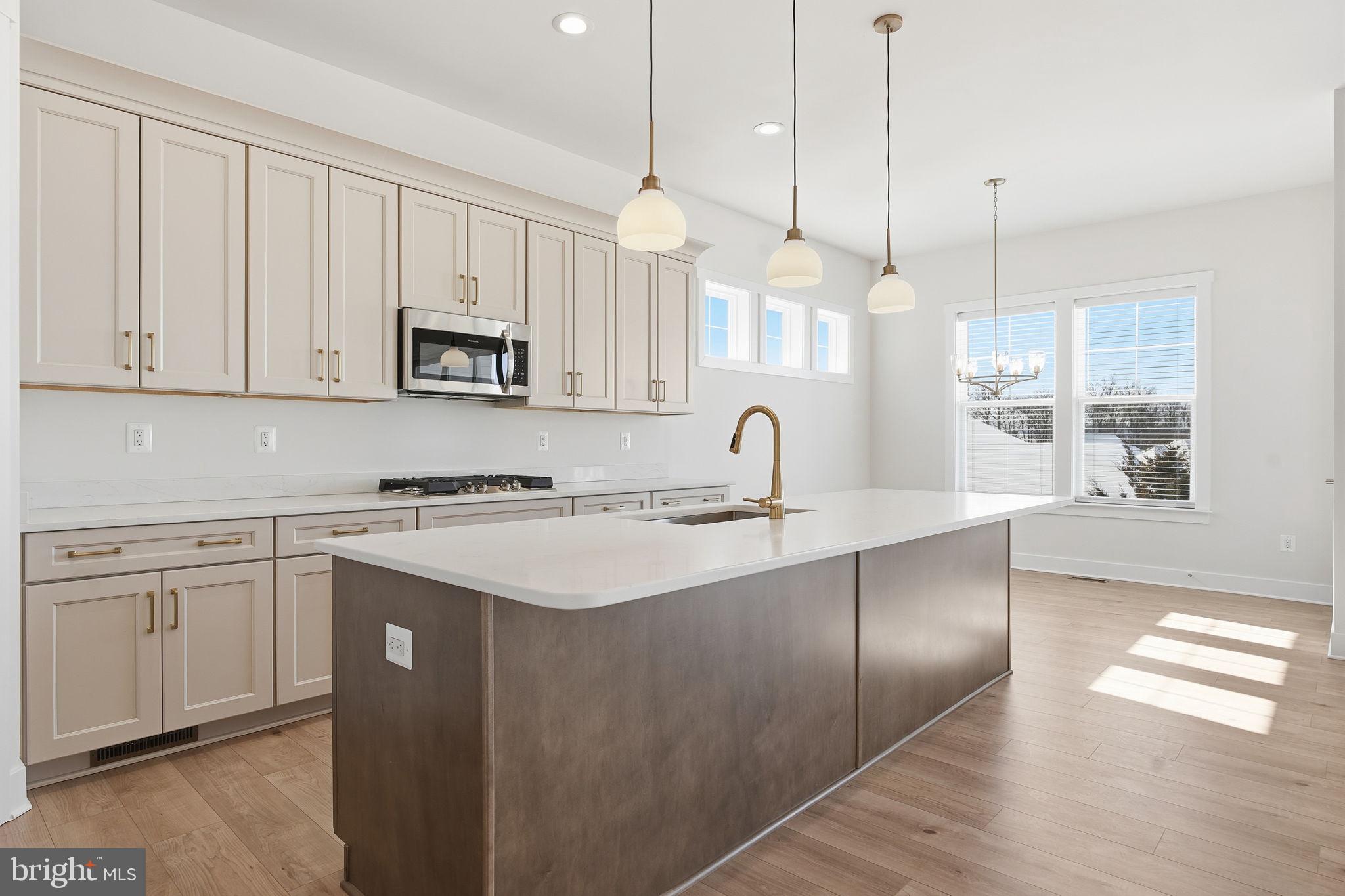 124 Bridge Valley Road Gettysburg, PA 17325 - Photo 12 of 34 a kitchen with stainless steel appliances granite countertop a sink a stove a refrigerator and white cabinets with wooden floor