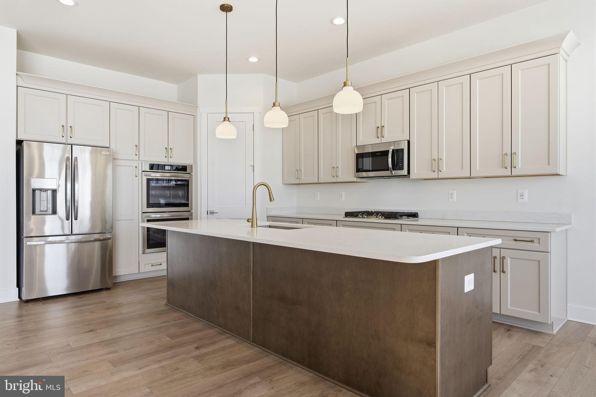 124 Bridge Valley Road Gettysburg, PA 17325 - Photo 13 of 34 a kitchen with stainless steel appliances granite countertop a refrigerator a stove a sink and white cabinets with wooden floor