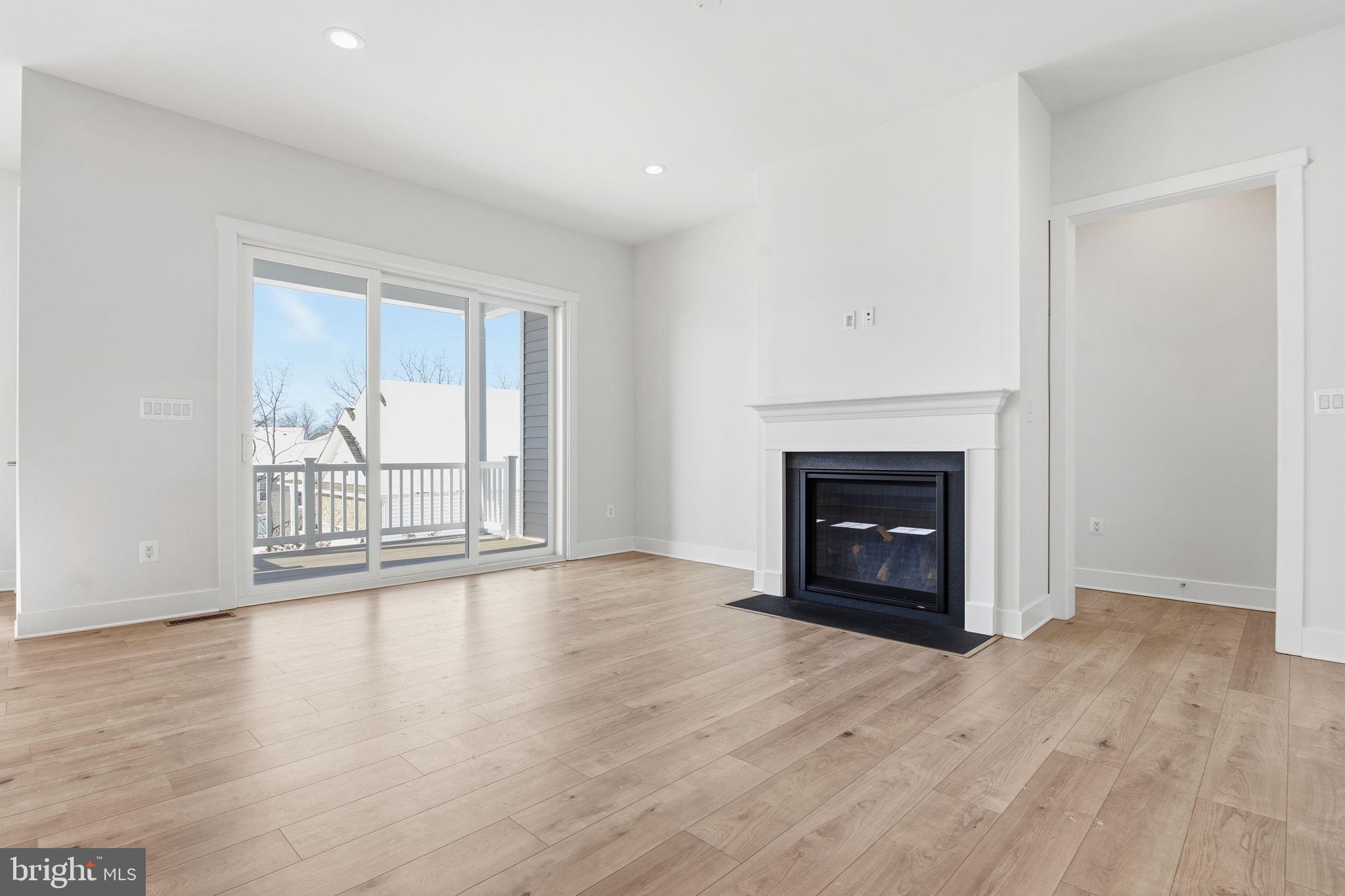 124 Bridge Valley Road Gettysburg, PA 17325 - Photo 6 of 34 a view of an empty room with wooden floor fireplace and a window