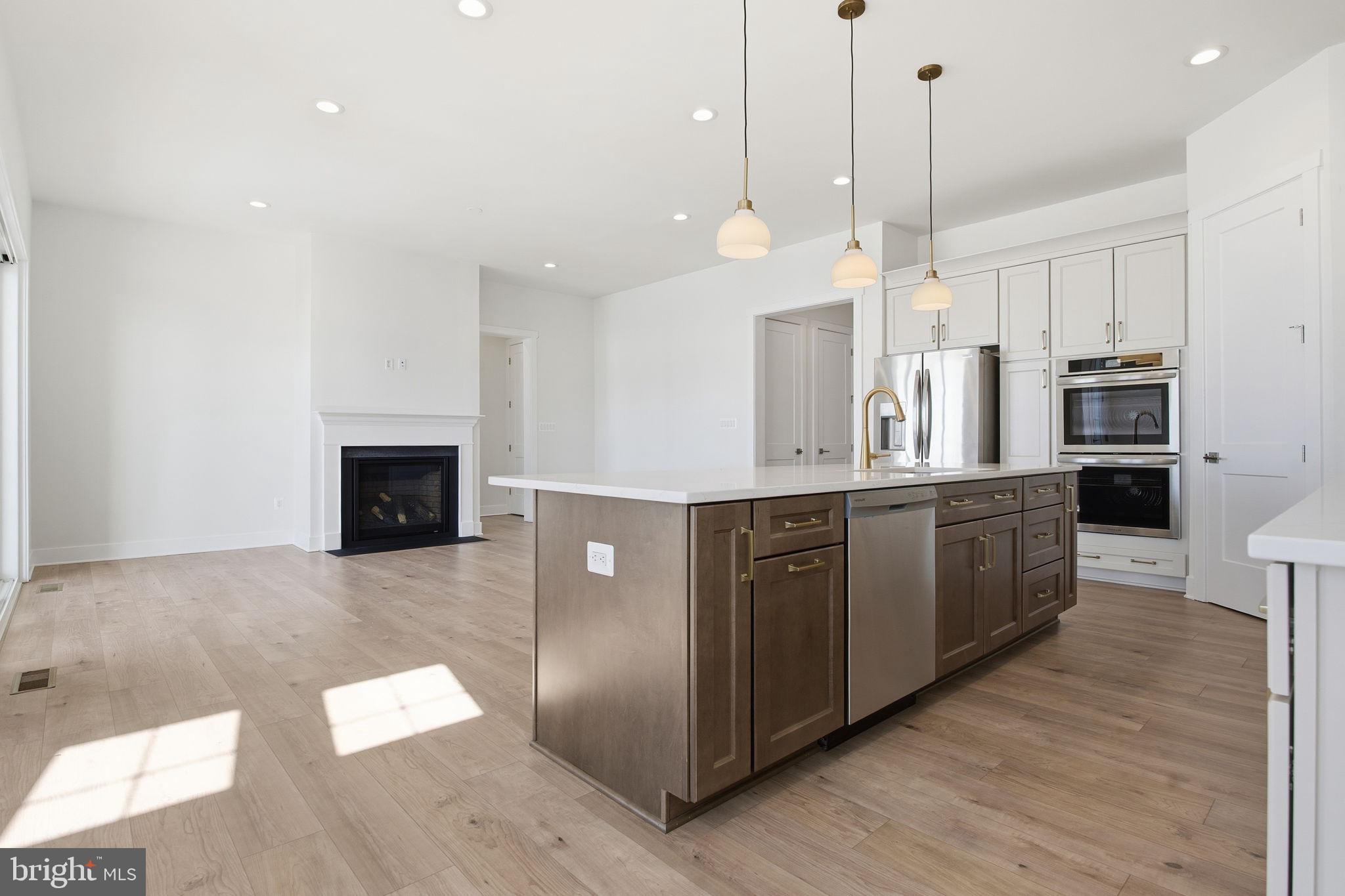 124 Bridge Valley Road Gettysburg, PA 17325 - Photo 8 of 34 a large kitchen with stainless steel appliances kitchen island granite countertop a refrigerator a oven and a wooden floor