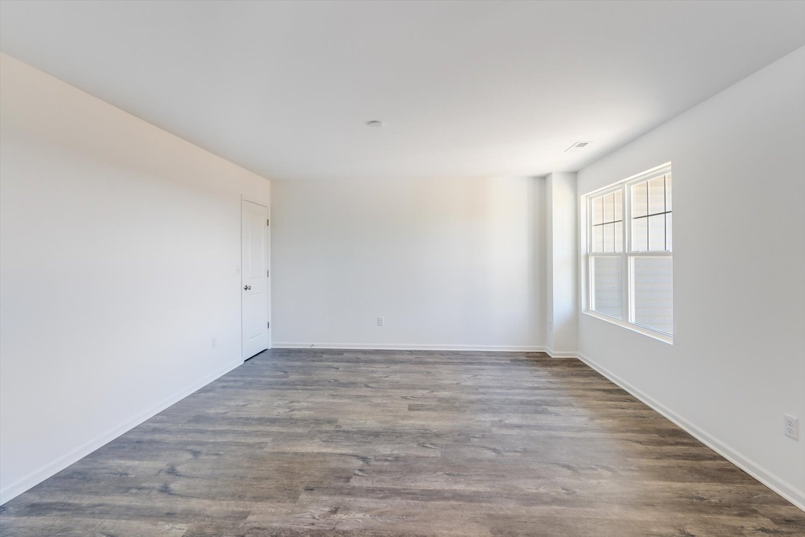 542 Comstock Road South Elgin, IL 60177 - Photo 8 of 32 a view of an empty room with wooden floor and a window