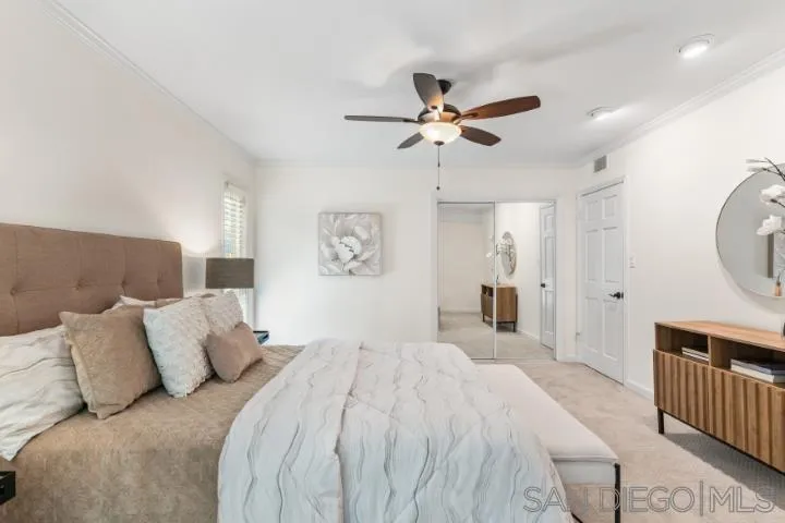 13311 Fallen Leaf Road Poway, CA 92064 - Photo 19 of 30 a spacious bedroom with a bed and a chandelier