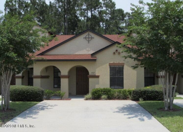 a front view of a house with yard