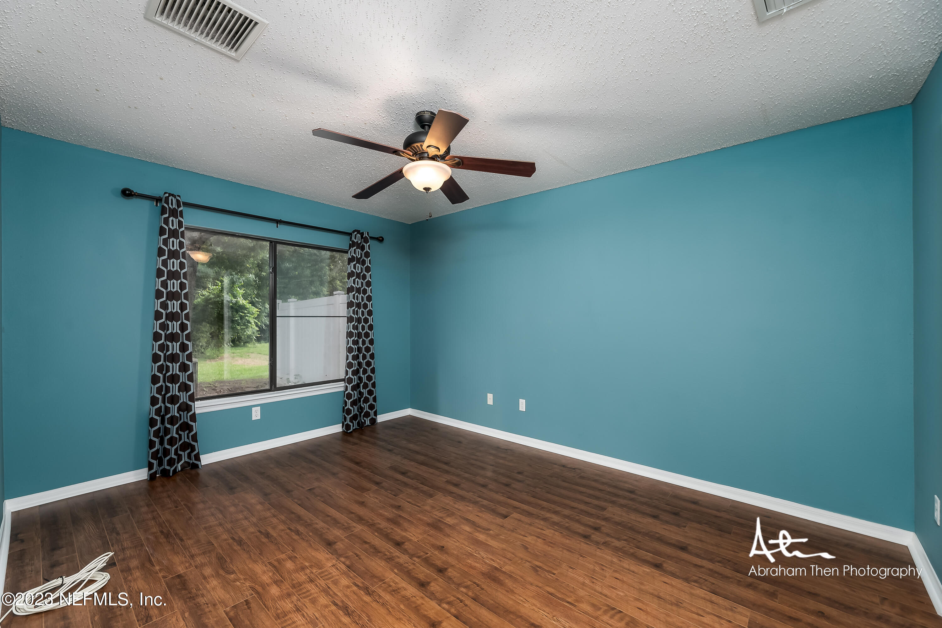 742 Ginger Mill Drive St. Johns, FL 32259 - Photo 14 of 32 an empty room with wooden floor and windows