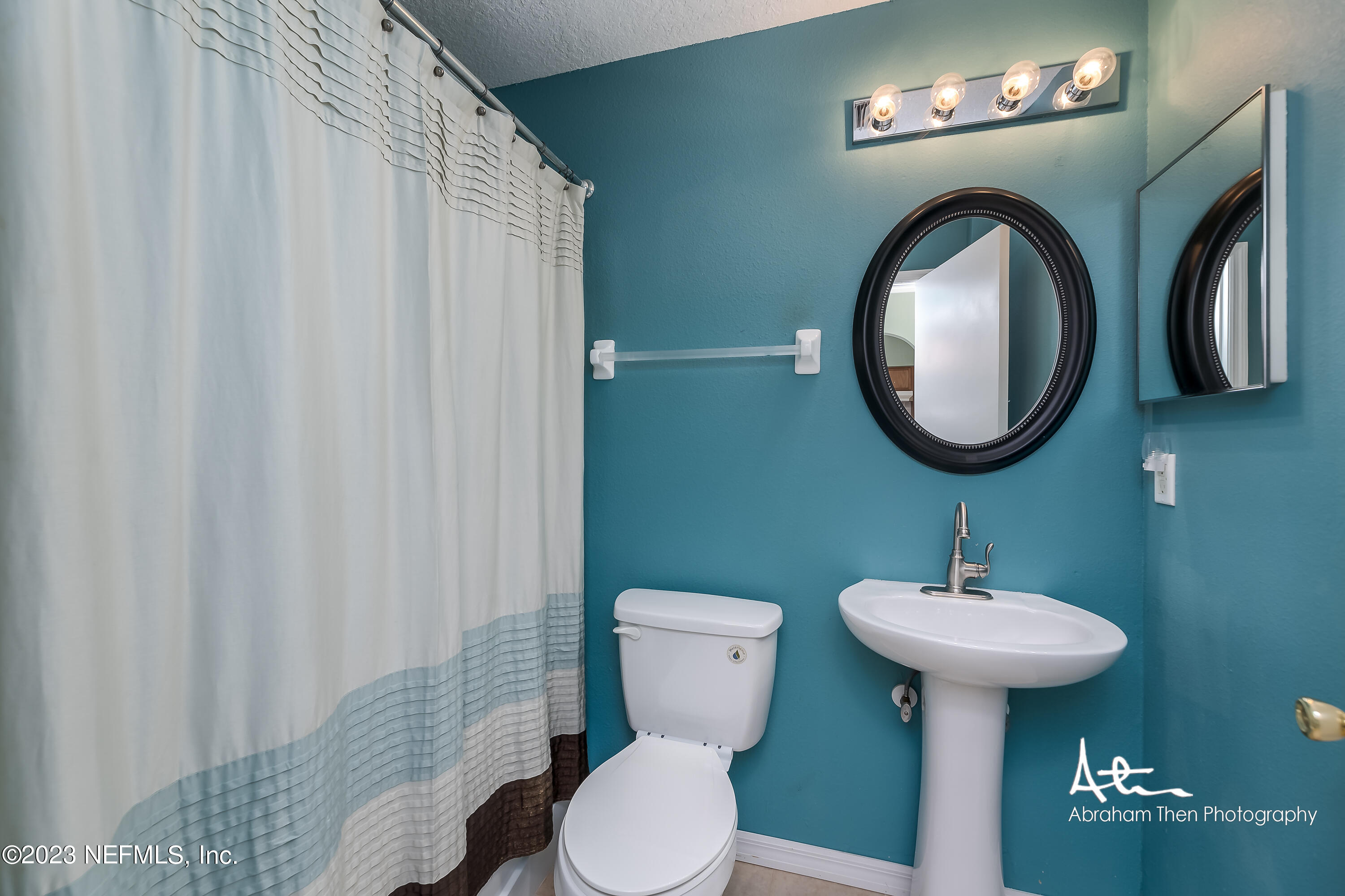 742 Ginger Mill Drive St. Johns, FL 32259 - Photo 20 of 32 a bathroom with a toilet sink and mirror