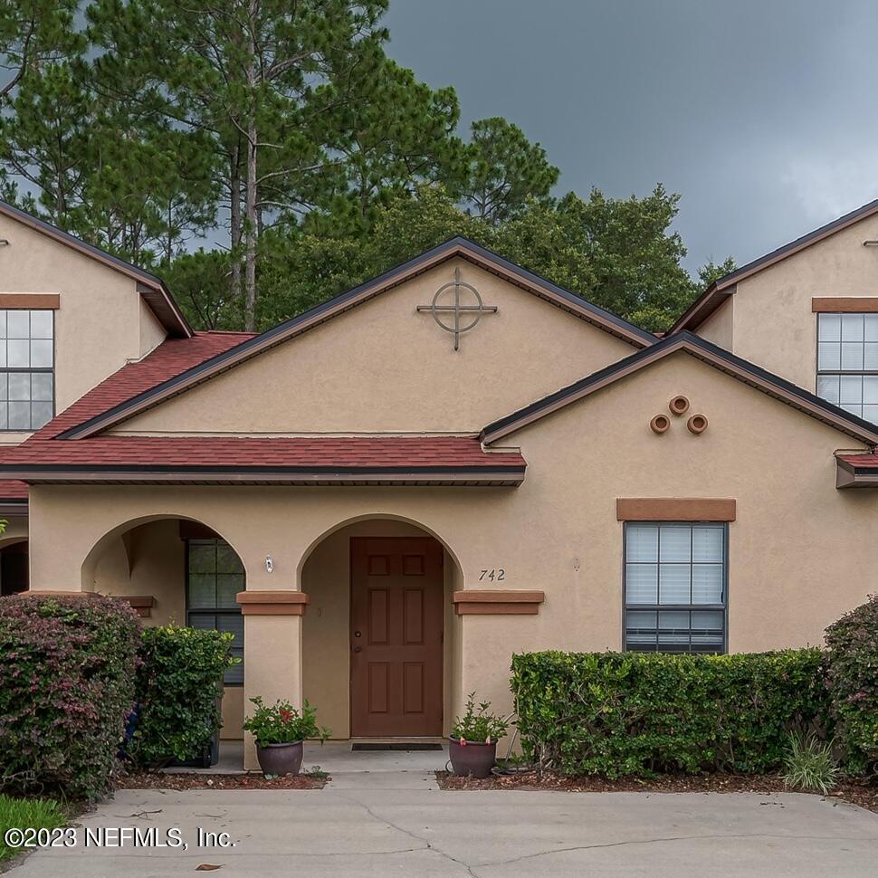 742 Ginger Mill Drive St. Johns, FL 32259 - Photo 2 of 32 a front view of a house with plants