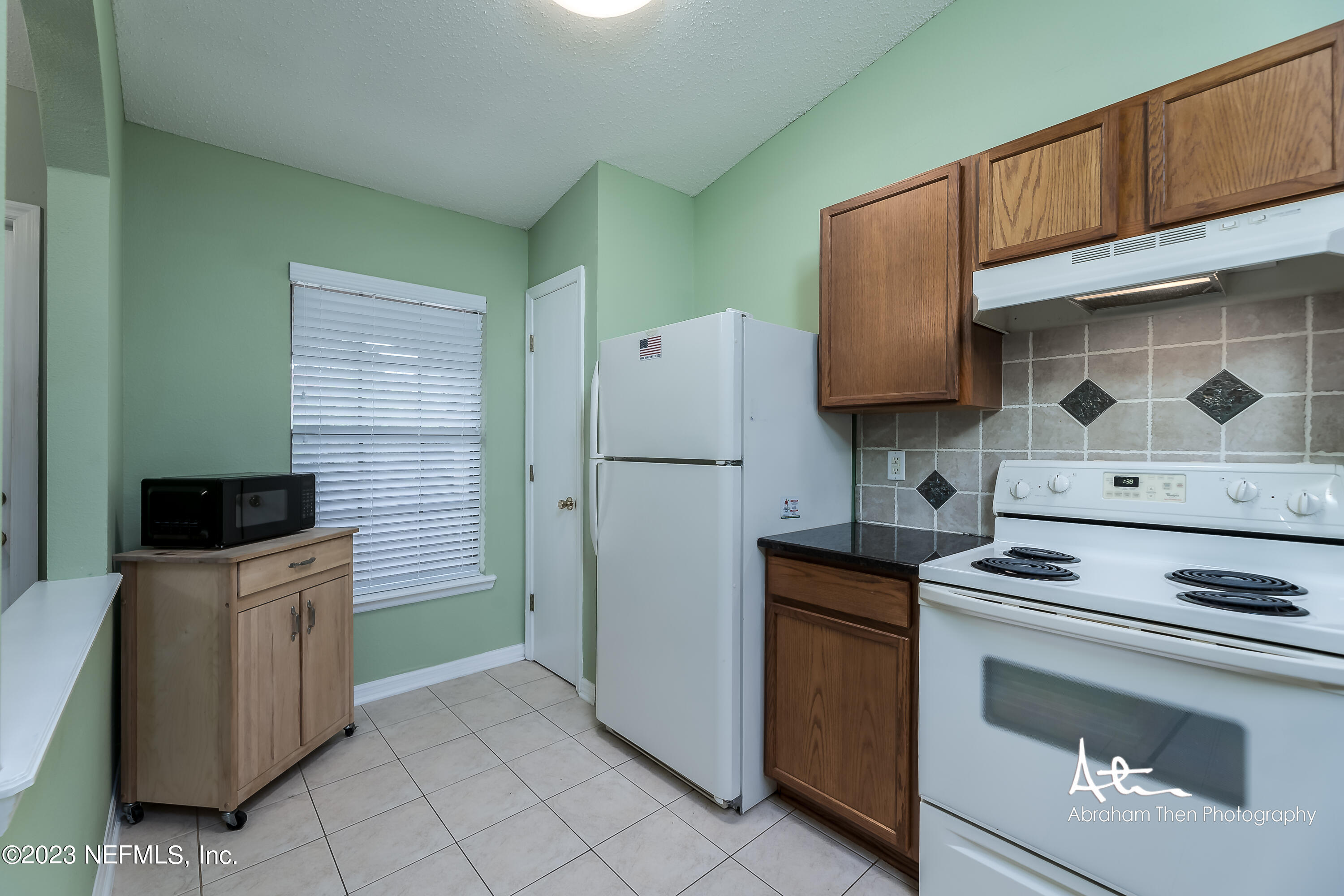 742 Ginger Mill Drive St. Johns, FL 32259 - Photo 6 of 32 a kitchen with a stove microwave and refrigerator