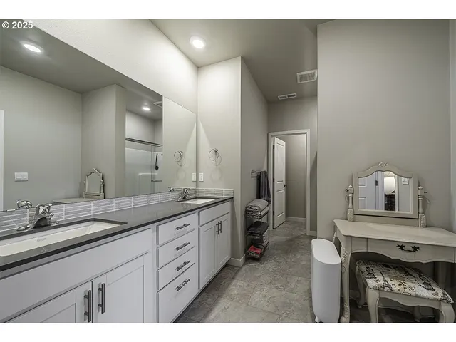 a spacious bathroom with a granite countertop sink a mirror and a