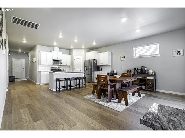 a living room with lots of furniture and kitchen view