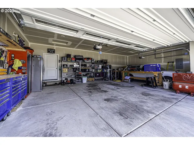 a bedroom with a bed and a potted plant on the dresser