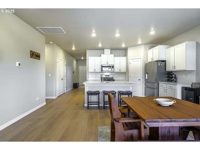 a kitchen with kitchen island a sink table and chairs
