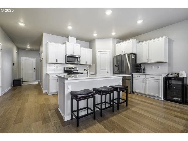 a kitchen with kitchen island wooden cabinets and stainless steel appliances