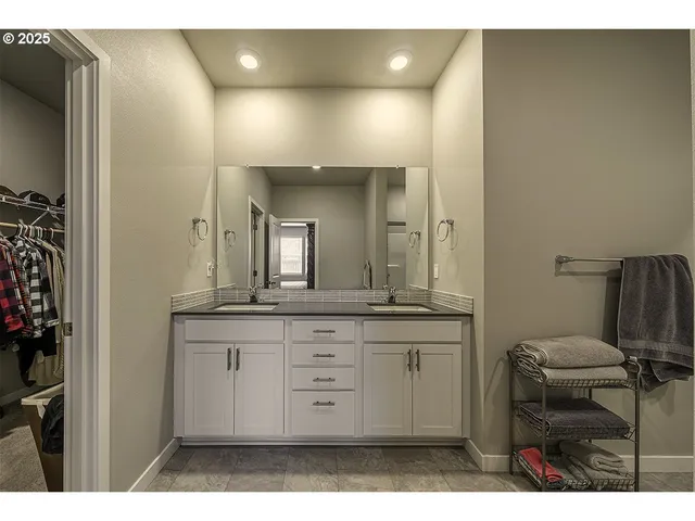 a bathroom with a granite countertop sink a toilet and a mirror