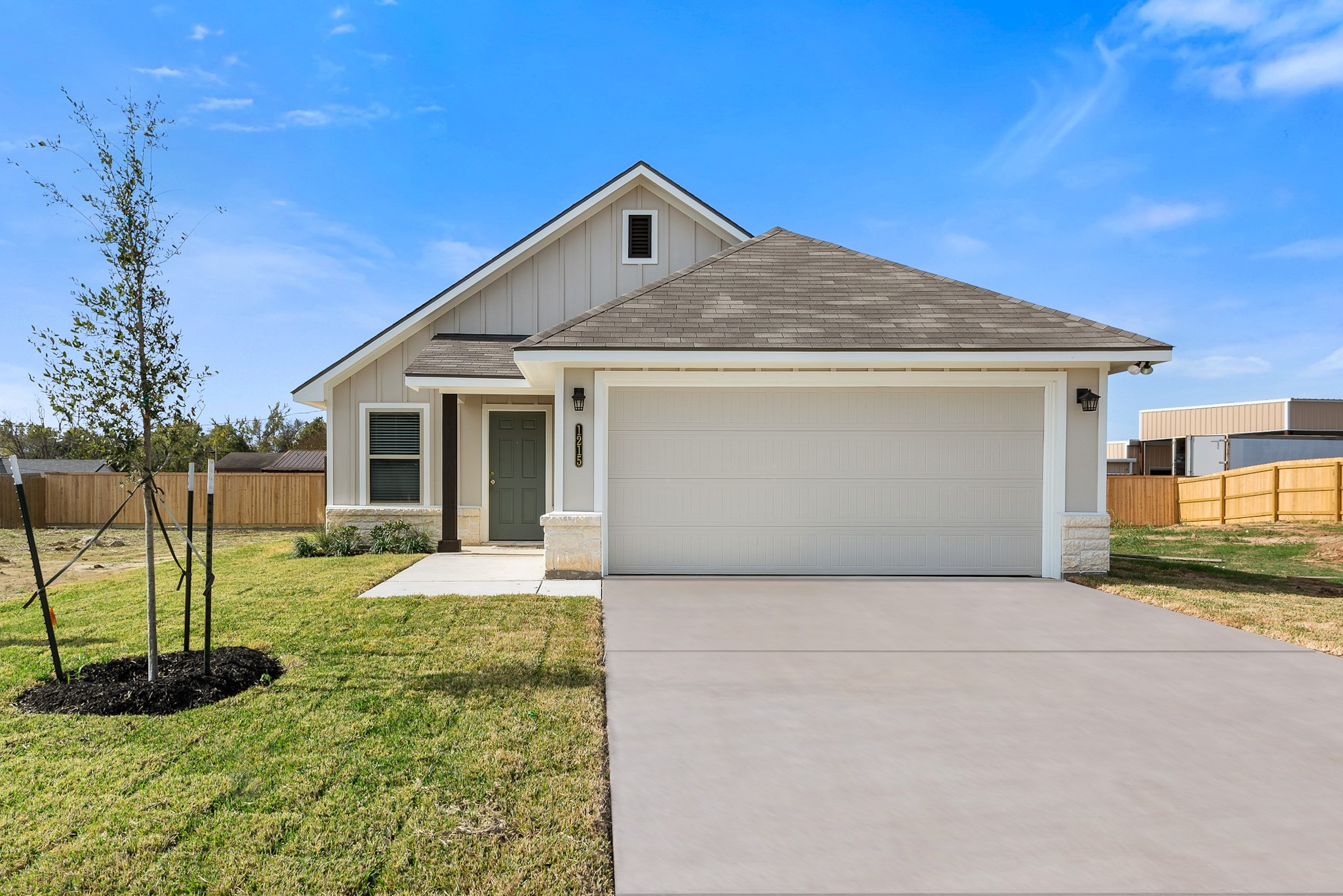 1215 High Street Navasota, TX 77868 - Photo 1 of 23 a front view of a house with a yard and garage