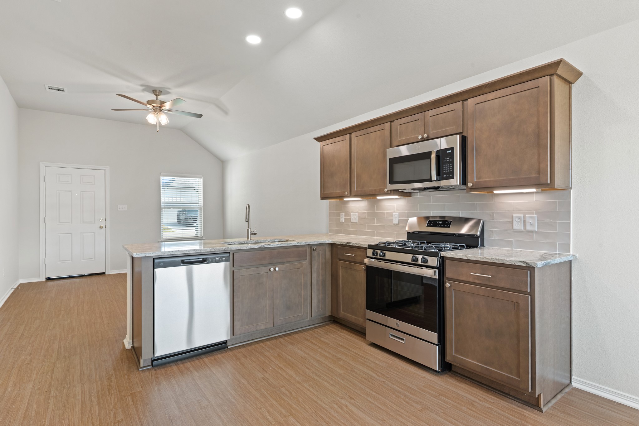 1215 High Street Navasota, TX 77868 - Photo 11 of 23 a kitchen with stainless steel appliances granite countertop a stove a sink and a microwave