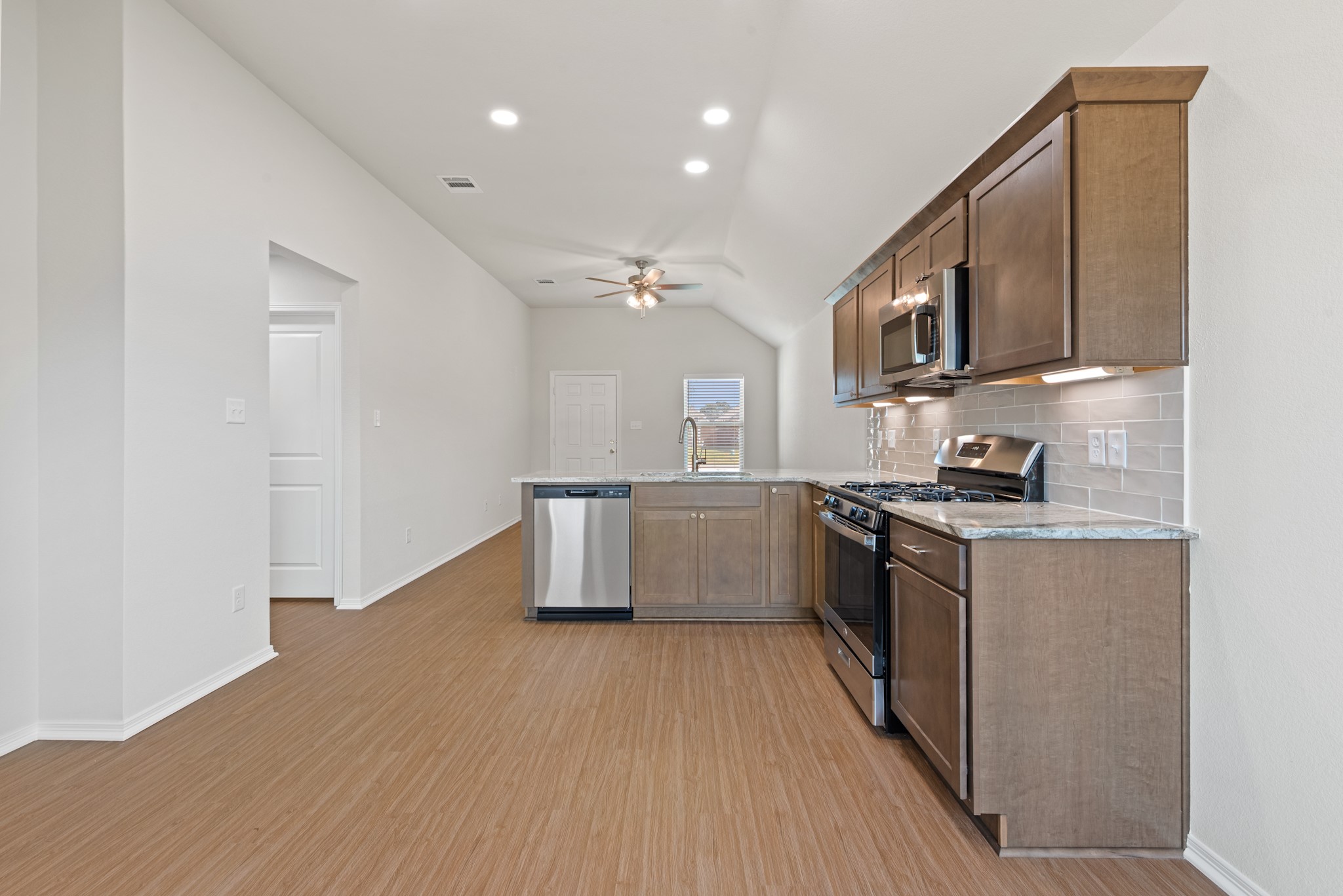 1215 High Street Navasota, TX 77868 - Photo 13 of 23 a kitchen with stainless steel appliances granite countertop a stove a sink and a refrigerator