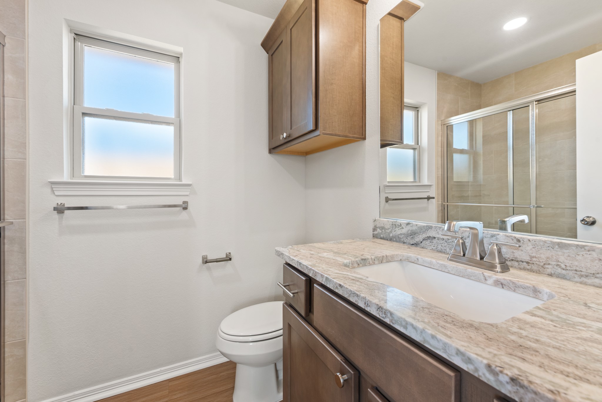 1215 High Street Navasota, TX 77868 - Photo 16 of 23 a bathroom with a granite countertop toilet sink and mirror