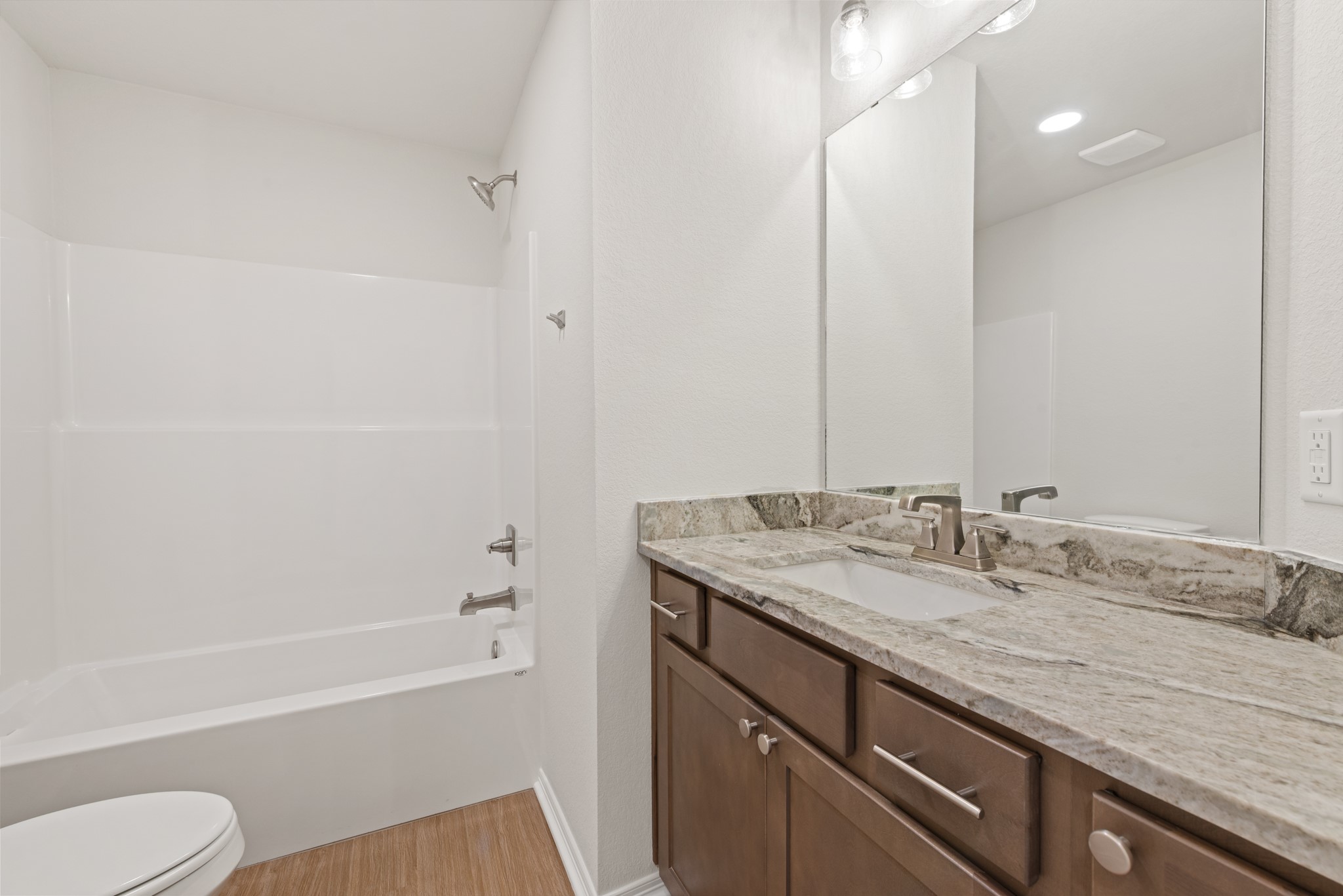 1215 High Street Navasota, TX 77868 - Photo 20 of 23 a bathroom with a granite countertop sink toilet and shower