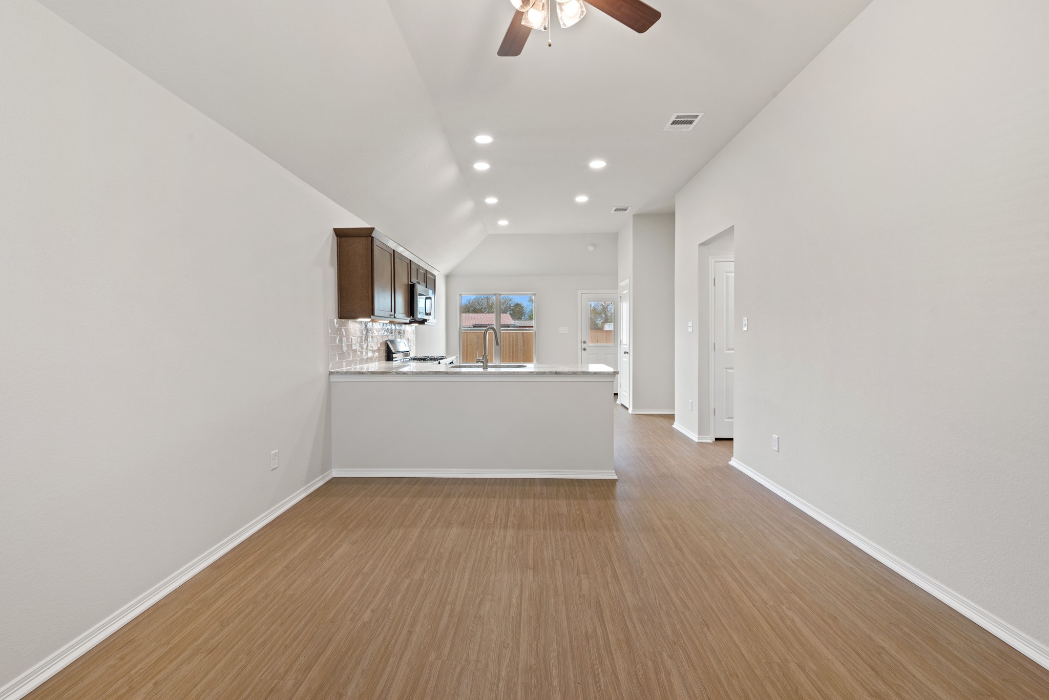 1215 High Street Navasota, TX 77868 - Photo 4 of 23 a view of a kitchen with wooden floor and a sink