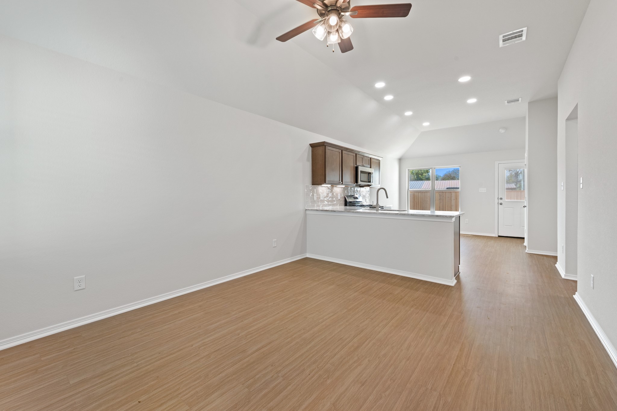 1215 High Street Navasota, TX 77868 - Photo 6 of 23 a view of a kitchen with a dishwasher and wooden floor