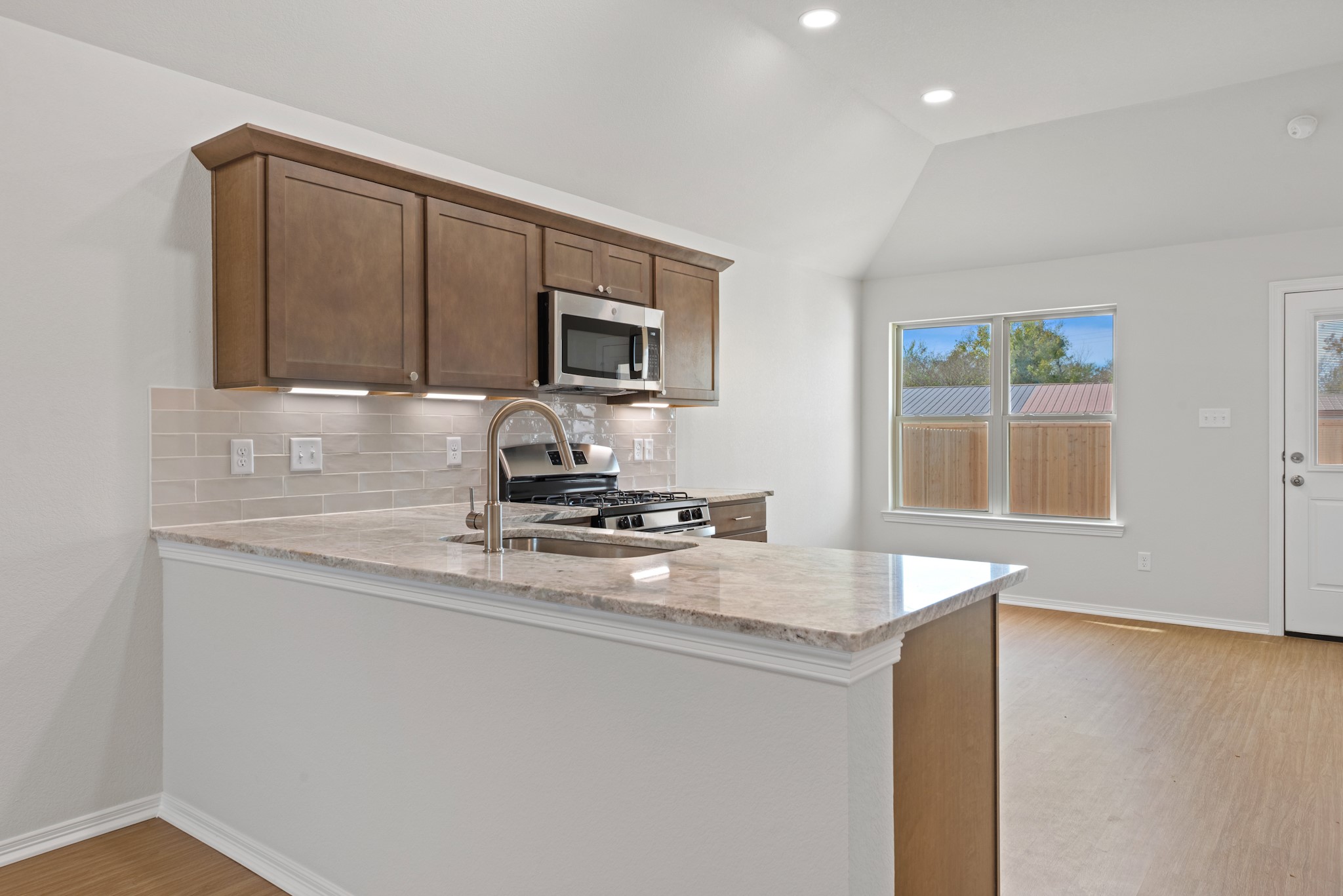 1215 High Street Navasota, TX 77868 - Photo 8 of 23 a kitchen with kitchen island a sink appliances and cabinets