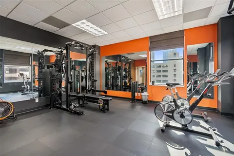 a room with a chair and flat screen tv