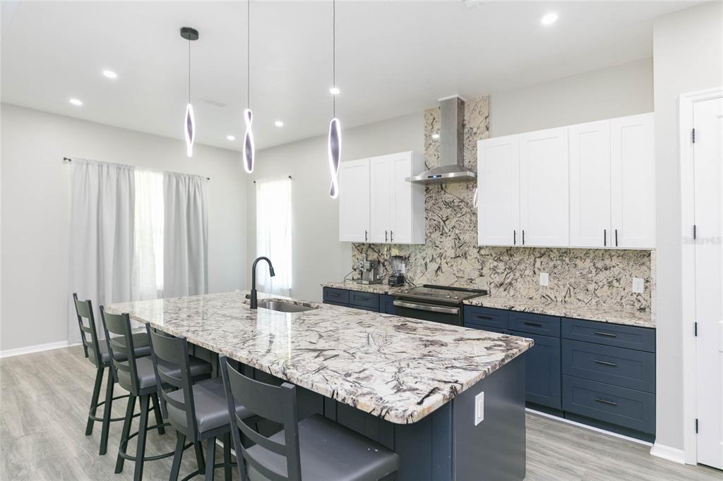 35369 Ruffing Road Dade City, FL 33523 - Photo 11 of 63 a kitchen with center island table and chairs in it