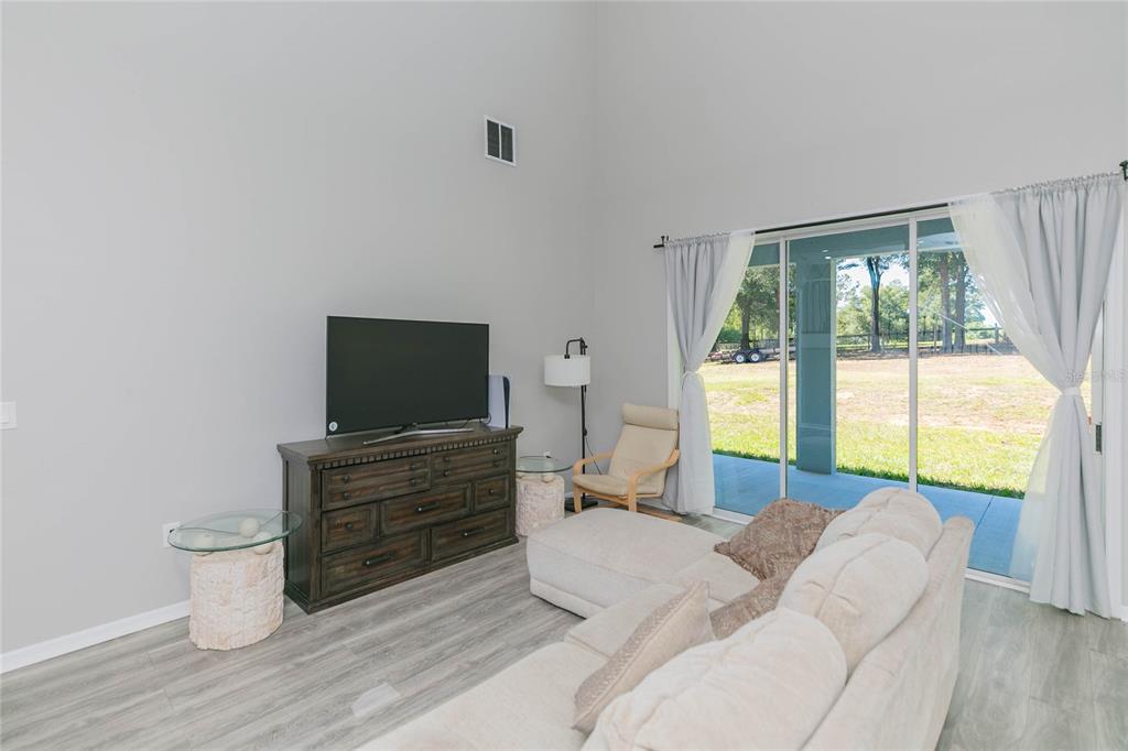 35369 Ruffing Road Dade City, FL 33523 - Photo 15 of 63 a bedroom with a bed and a flat screen tv