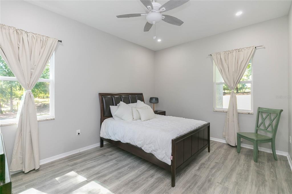 35369 Ruffing Road Dade City, FL 33523 - Photo 18 of 63 a bedroom with a bed and a chair