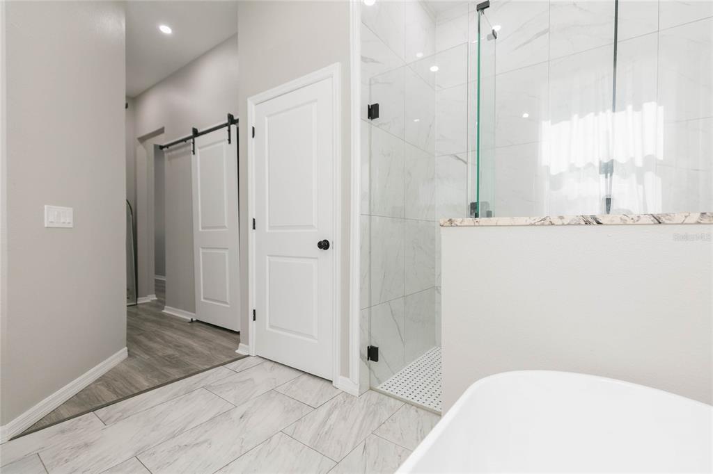 35369 Ruffing Road Dade City, FL 33523 - Photo 21 of 63 a bathroom with a bathtub and a shower