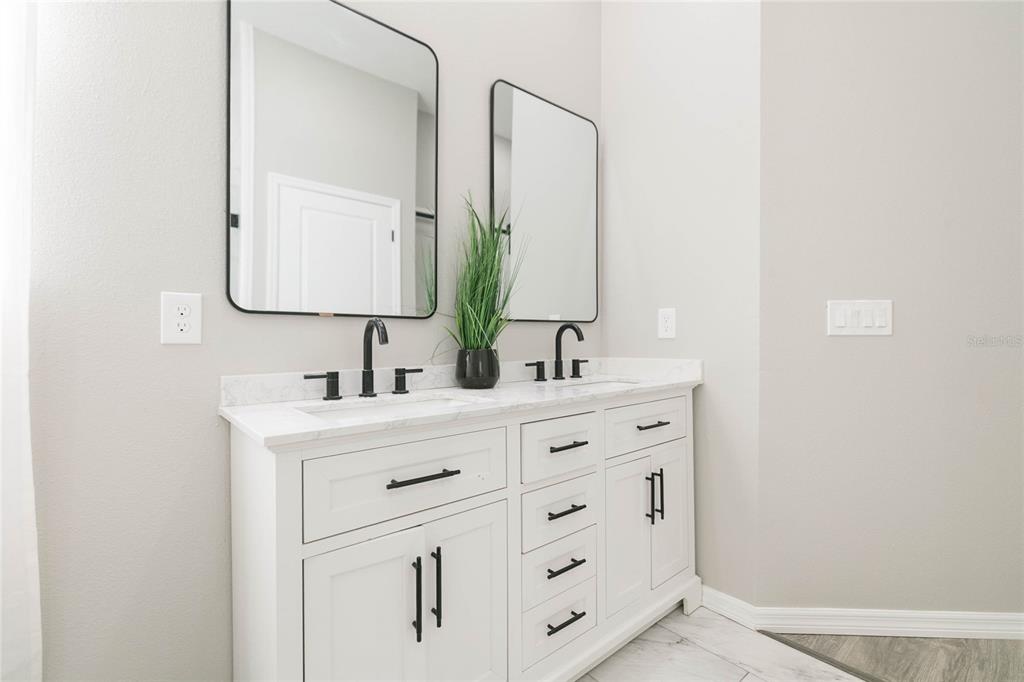 35369 Ruffing Road Dade City, FL 33523 - Photo 22 of 63 a bathroom with a double vanity sink mirror and