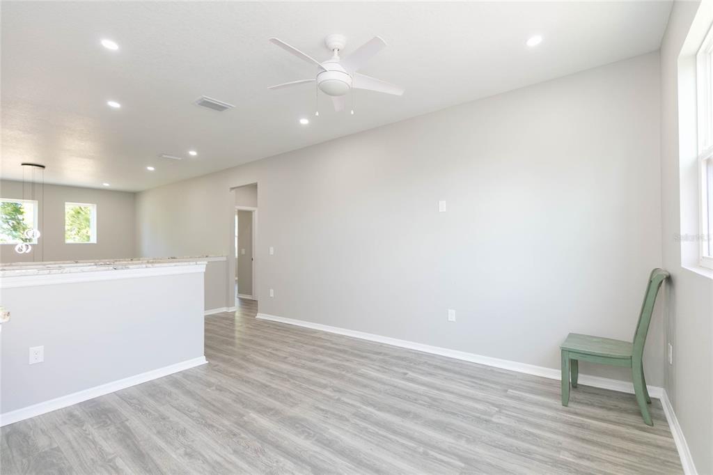 35369 Ruffing Road Dade City, FL 33523 - Photo 23 of 63 an empty room with wooden floor and a ceiling fan