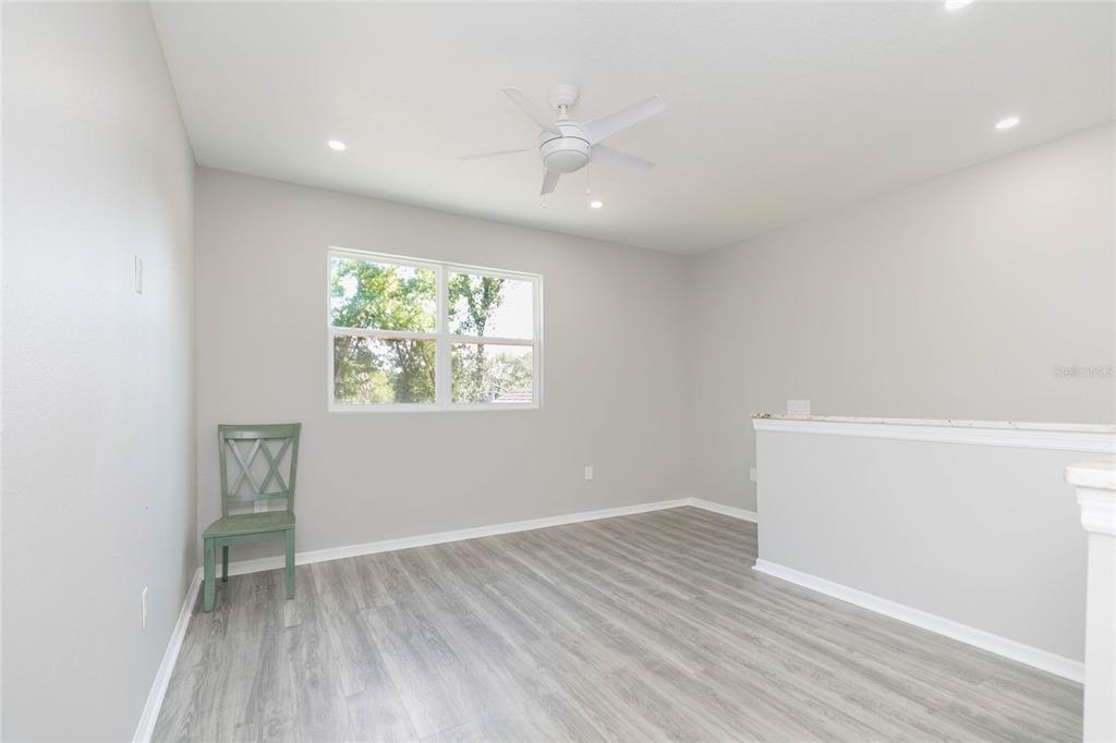 35369 Ruffing Road Dade City, FL 33523 - Photo 25 of 63 an empty room with wooden floor and windows