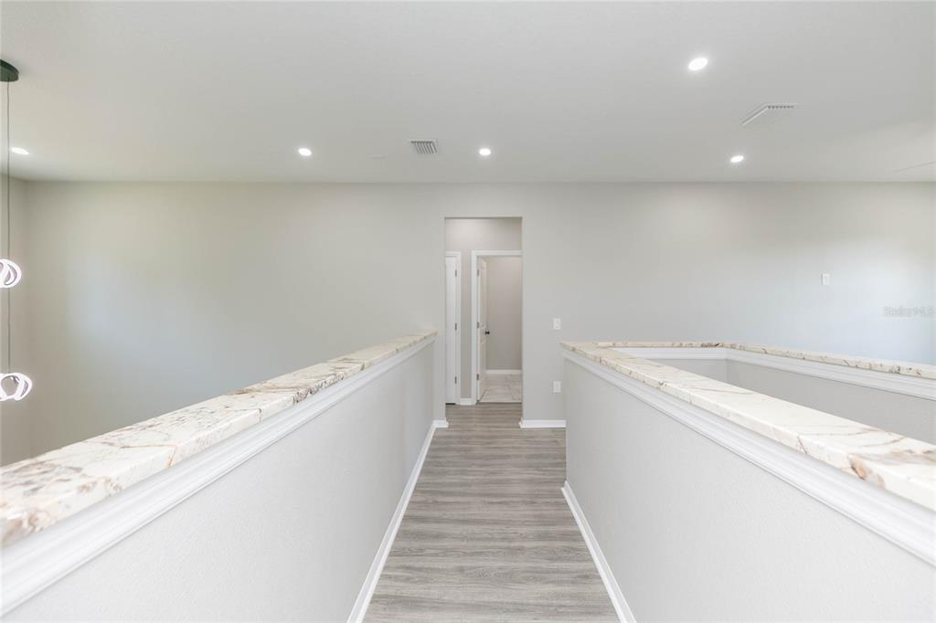 35369 Ruffing Road Dade City, FL 33523 - Photo 27 of 63 a view of a hallway with wooden floor