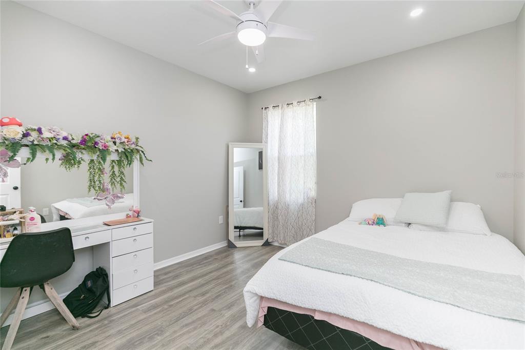 35369 Ruffing Road Dade City, FL 33523 - Photo 28 of 63 a bedroom with a bed table closet and a window
