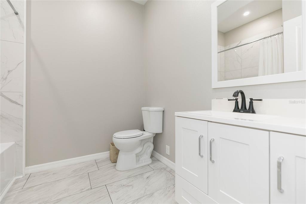 35369 Ruffing Road Dade City, FL 33523 - Photo 30 of 63 a bathroom with a toilet sink and mirror