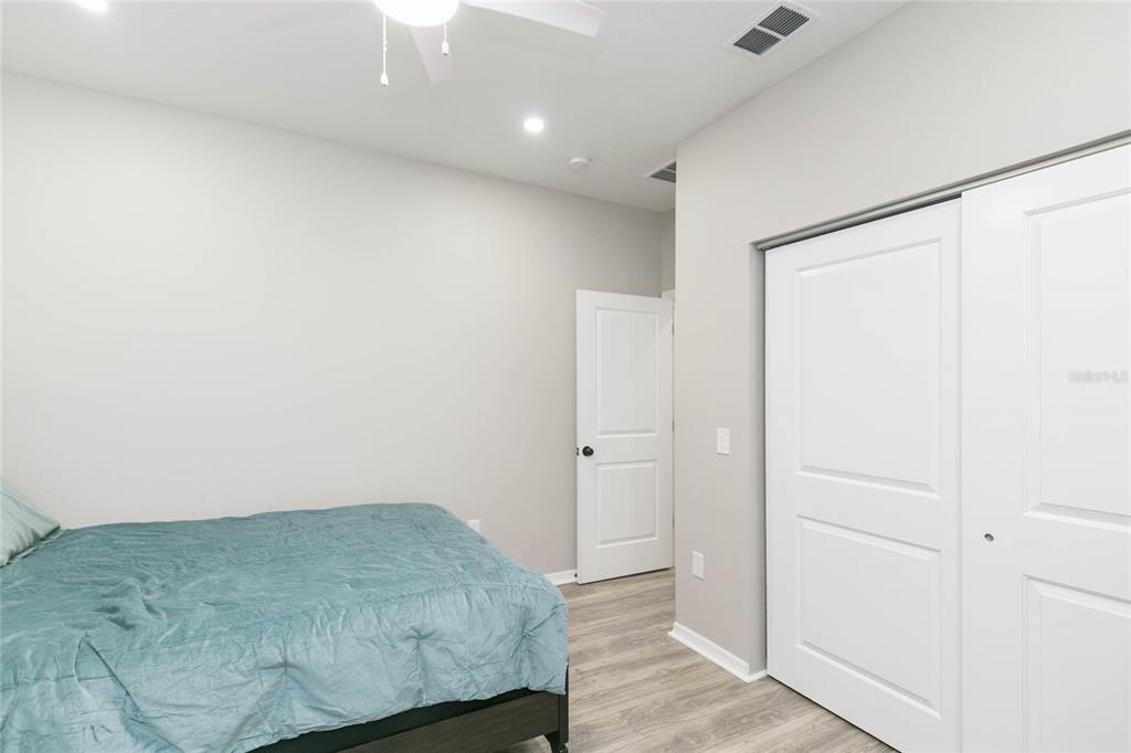 35369 Ruffing Road Dade City, FL 33523 - Photo 35 of 63 a room with a bed and wooden floor