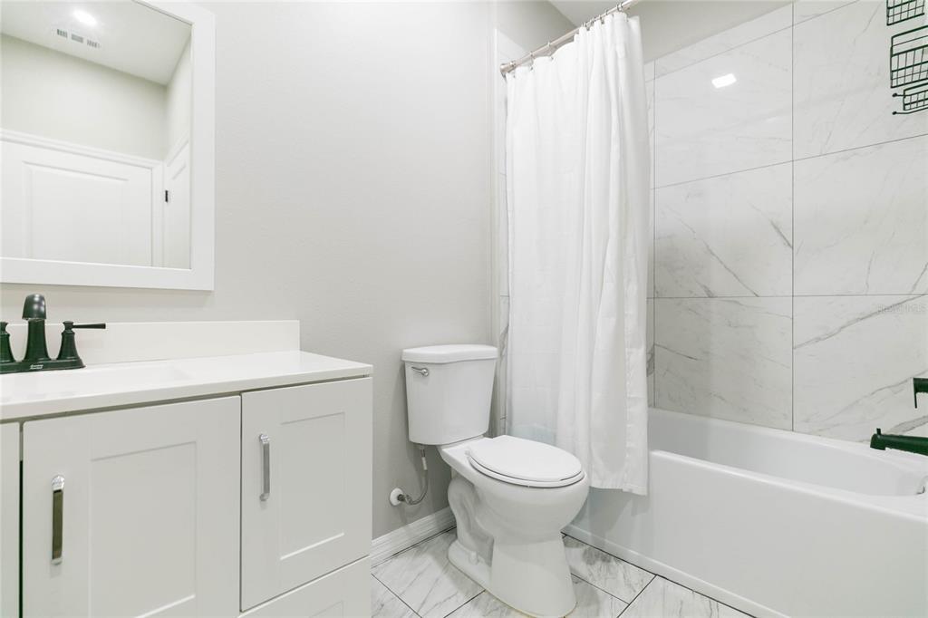 35369 Ruffing Road Dade City, FL 33523 - Photo 36 of 63 a bathroom with a sink a toilet and shower