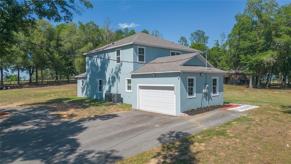 35369 Ruffing Road Dade City, FL 33523 - Photo 41 of 63 a front view of a house with a yard