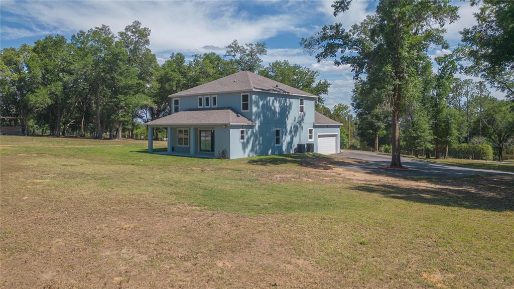 35369 Ruffing Road Dade City, FL 33523 - Photo 50 of 63 a front view of a house with a yard