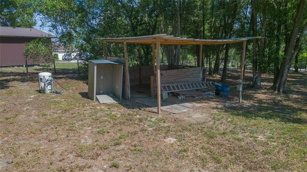 35369 Ruffing Road Dade City, FL 33523 - Photo 51 of 63 a view of a backyard with floor to ceiling window and wooden fence