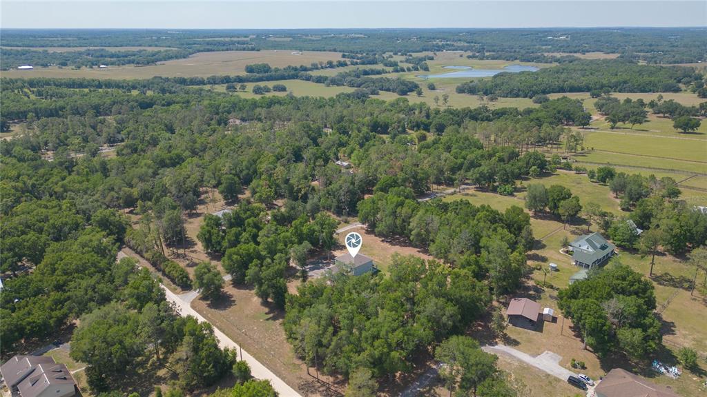 35369 Ruffing Road Dade City, FL 33523 - Photo 53 of 63 an aerial view of green landscape with trees houses and mountain view